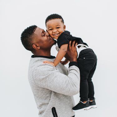 Father kissing the little son cheek